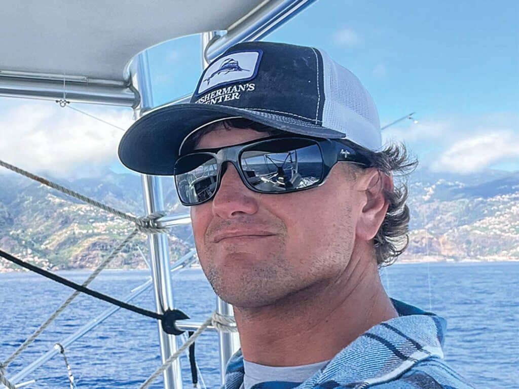 Capt. Newt Cagle on a sport-fishing boat. The ocean can be seen in the horizon.