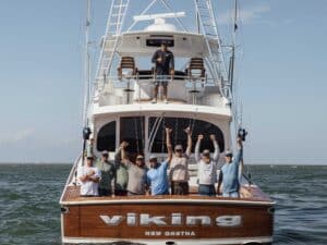 Team Viking 74 celebrating in the cockpit of their fishing boat.