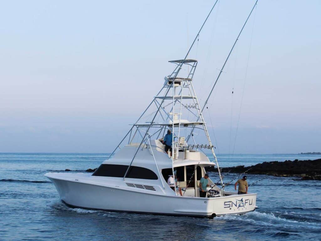 The Snafu sport-fishing boat cruises on the water out for a day of fishing.