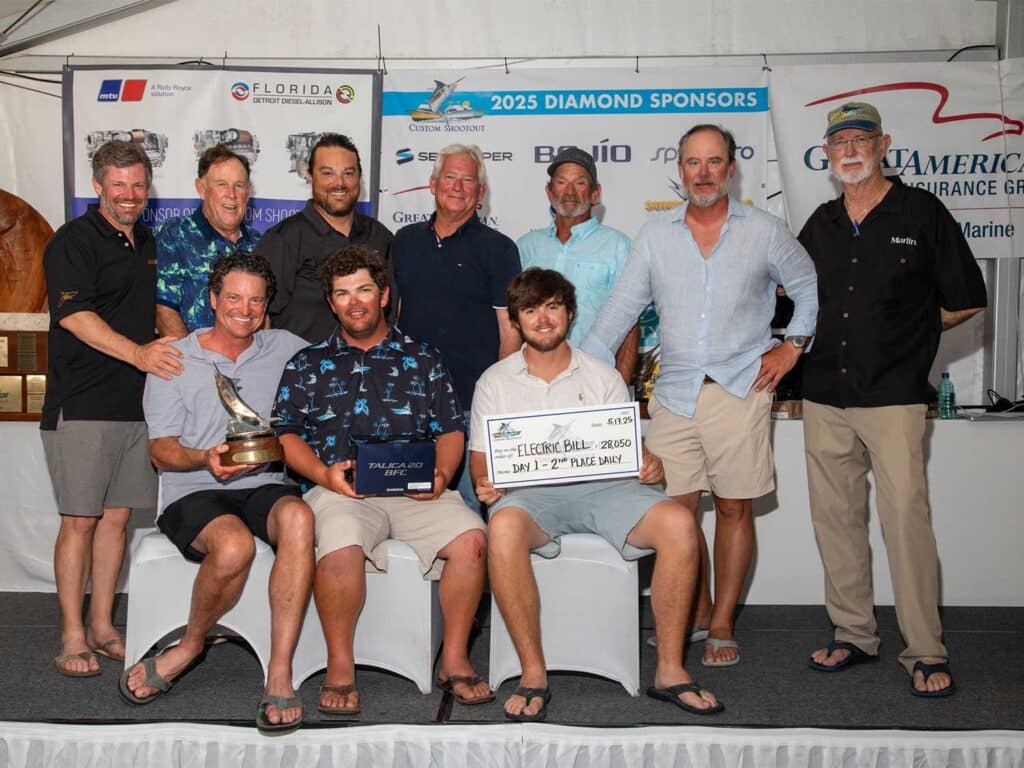 A team of anglers pose in celebration.