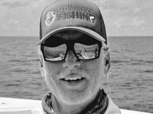 A black and white portrait of Glenn Huges.