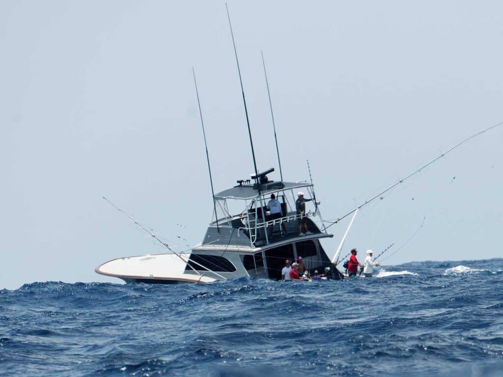 A sport-fishing boat on the water during rough waves.