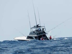 A sport-fishing boat on the water during rough waves.