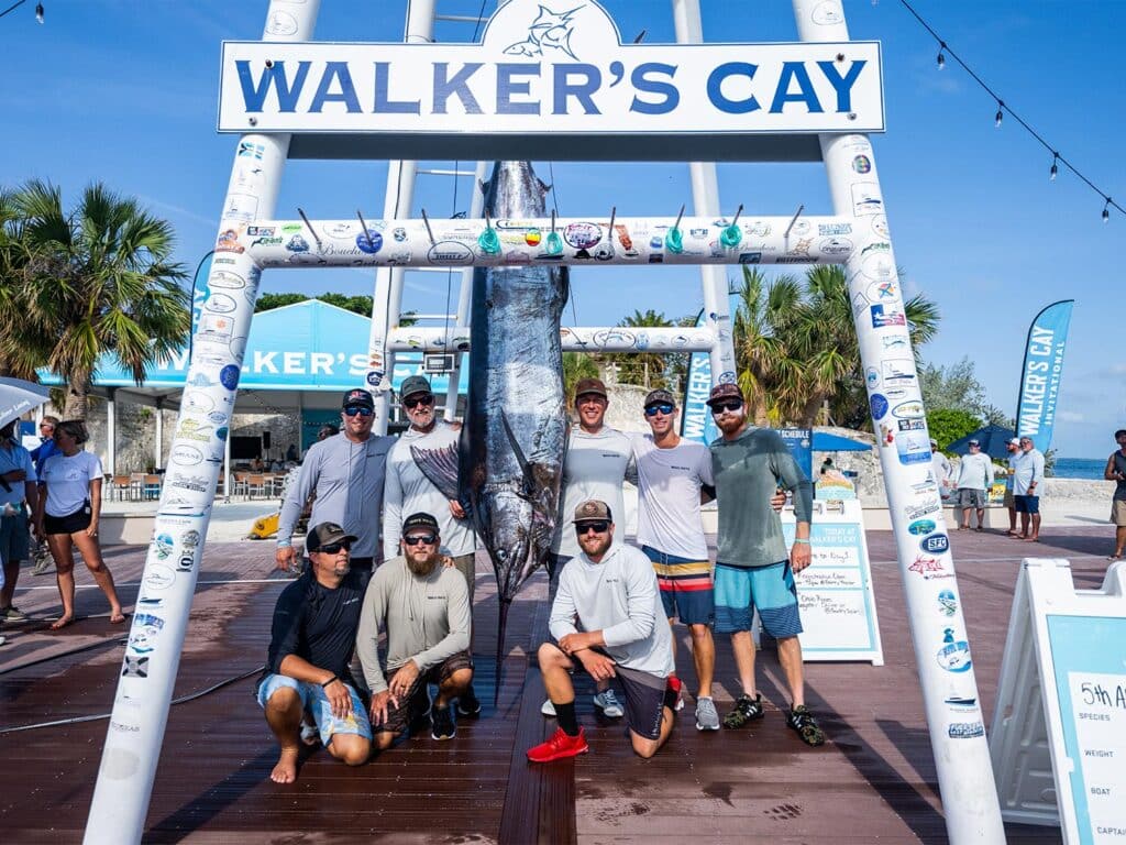 Team Wave Paver standing under the Walker's Cay dock sign.