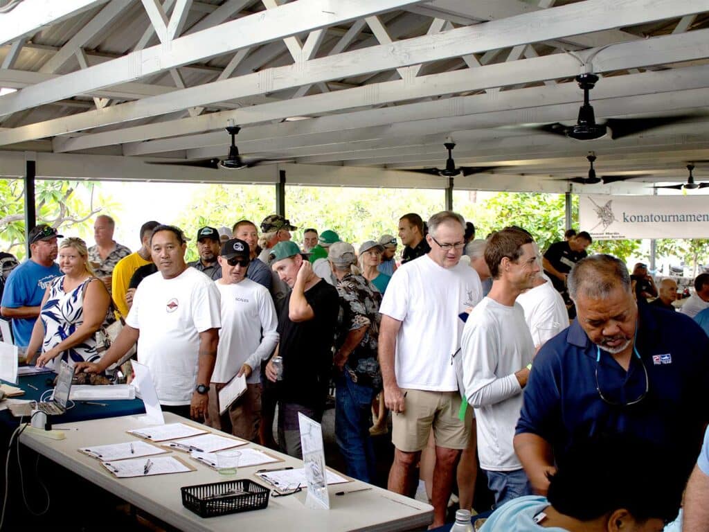 A group of captains gather during registration for the kick off meeting.