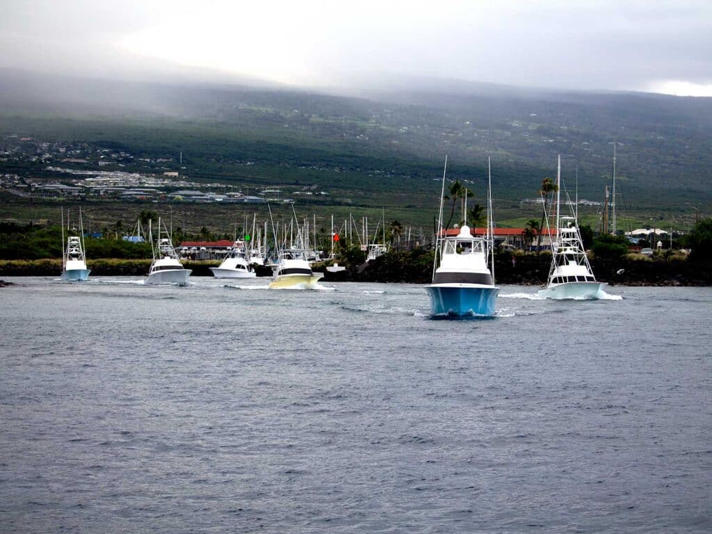 A fleet of sport-fishing boats take to the water for a day of fishing in Kona.