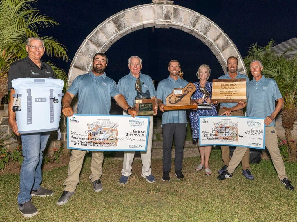 A team of anglers standing at an awards ceremony.
