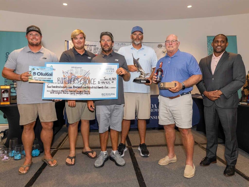 A team of anglers standing at an awards ceremony.