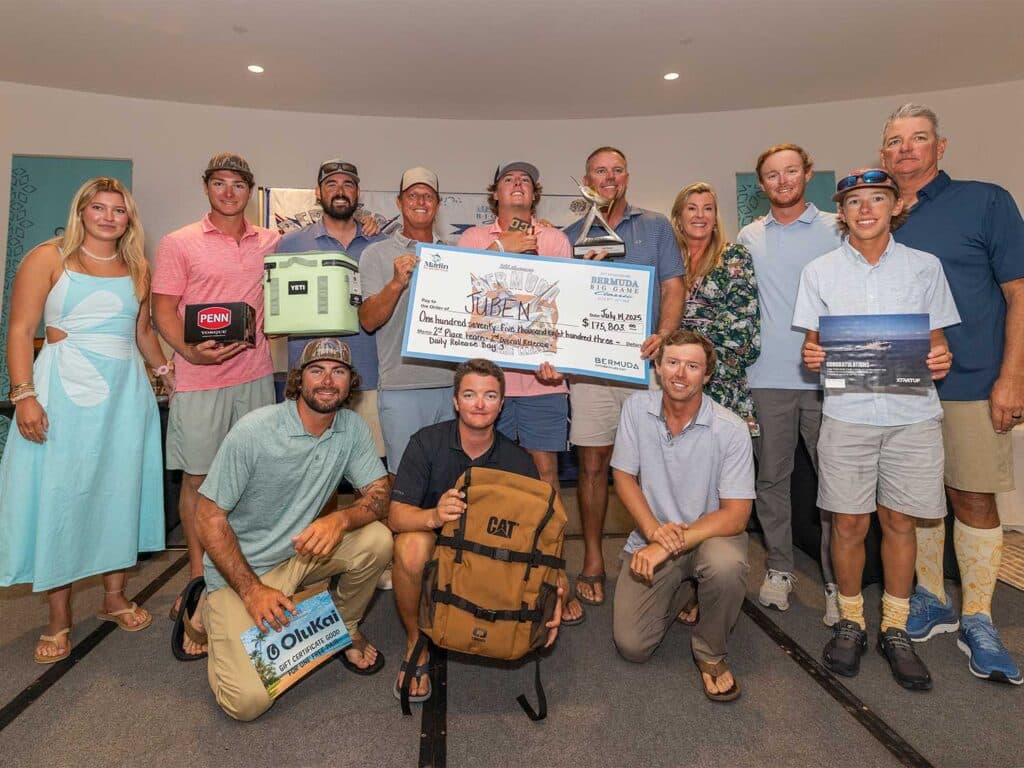 A team of anglers standing at an awards ceremony.