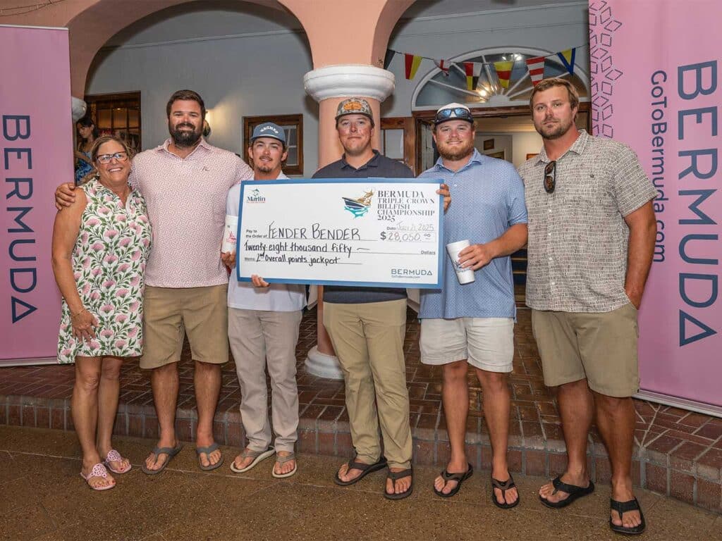 Team Fender Bender at the awards ceremony holding an over-sized check.