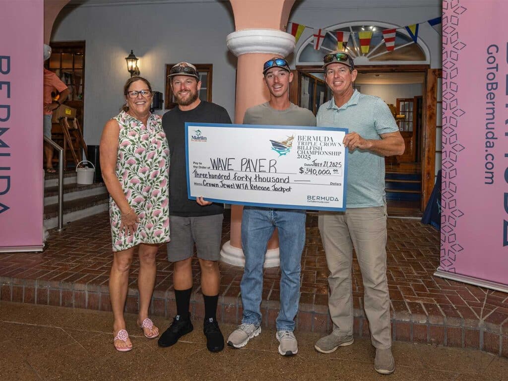 Team Wave Paver at the awards ceremony holding an over-sized check.
