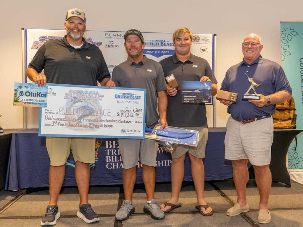 Team Builder's Choice at the awards ceremony of the 2025 Bermuda Billfish Blast. They hold oversized checks, trophies, and awards from tournament sponsors.