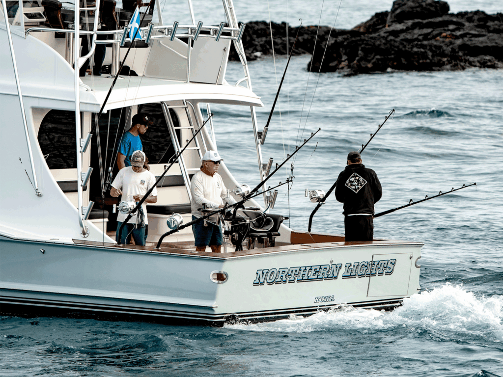 A team of anglers in the cockpit of a sport-fishing boat ready for the day of fishing.