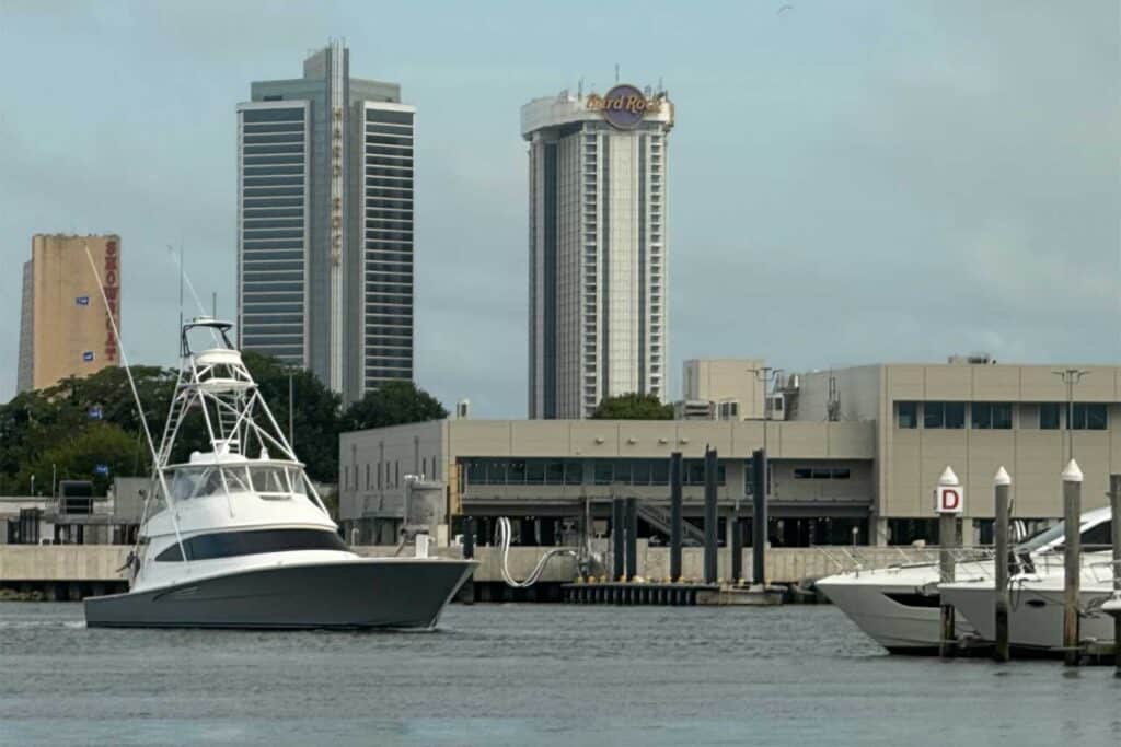 A sport-fishing boat cruises across the water near the Atlantic City harbor