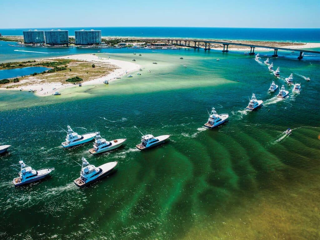 Aerial view of the Orange Beach bay as a fleet of sport-fishing boats cruise across the water.