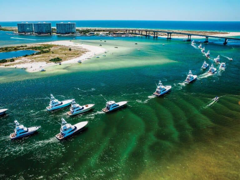 Aerial view of the Orange Beach bay as a fleet of sport-fishing boats cruise across the water.