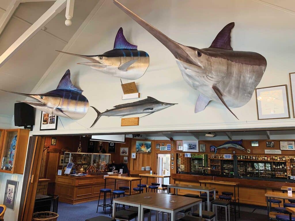 View of a fishing club wall with trophy mounts.