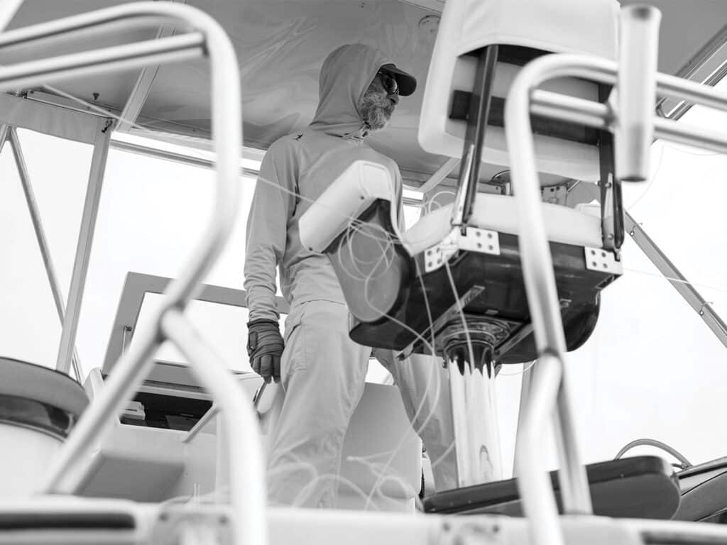 A black and white image of Capt. Terry standing at the helm.