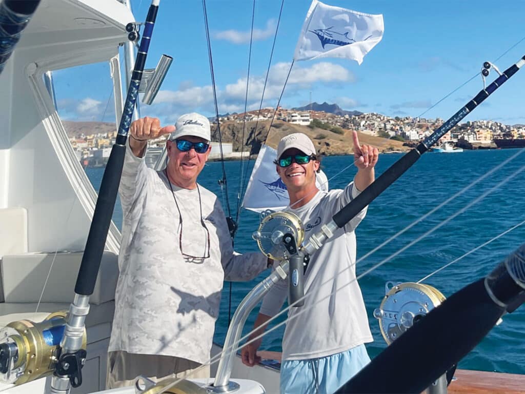 Two anglers in the cockpit of a sport-fishing boat.