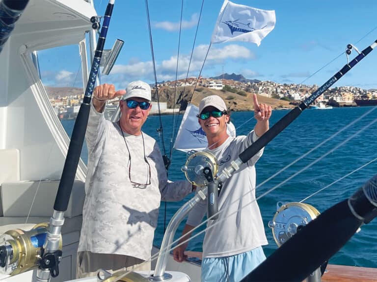 Two anglers in the cockpit of a sport-fishing boat.