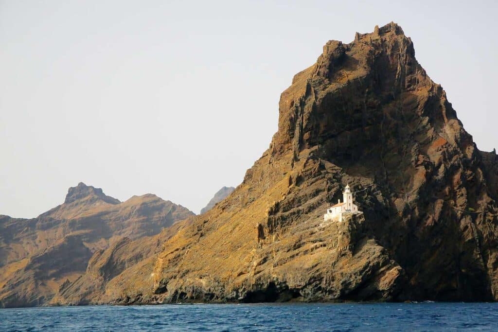 A lighthouse perched on the mountainside of a rocky island in Cape Verde.