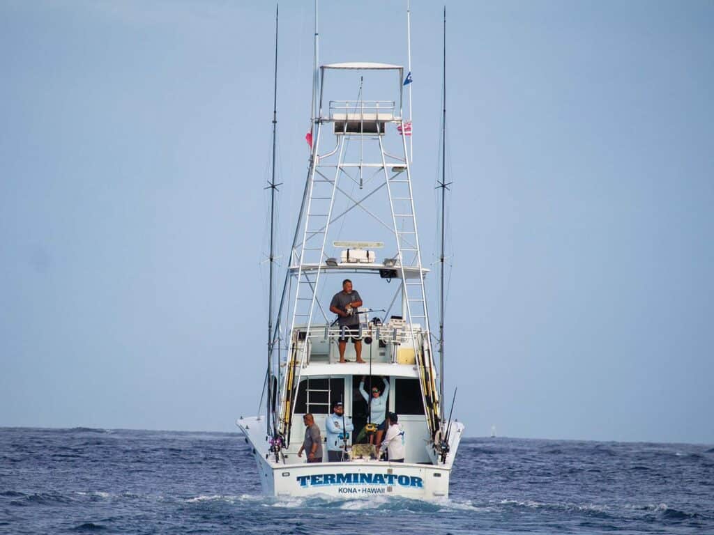 A sport-fishing boat named 'Terminator' makes its way across the water.