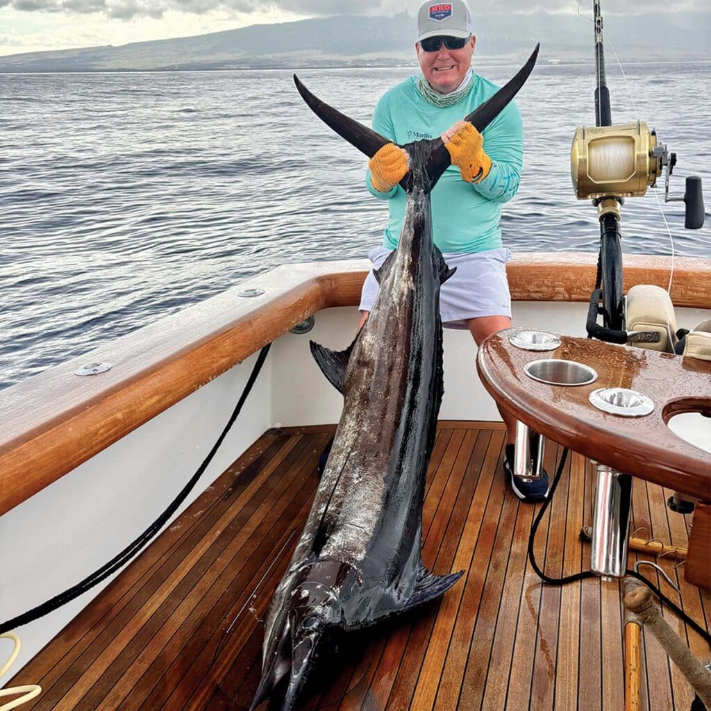 Angler poses with first ever caught blue marlin.