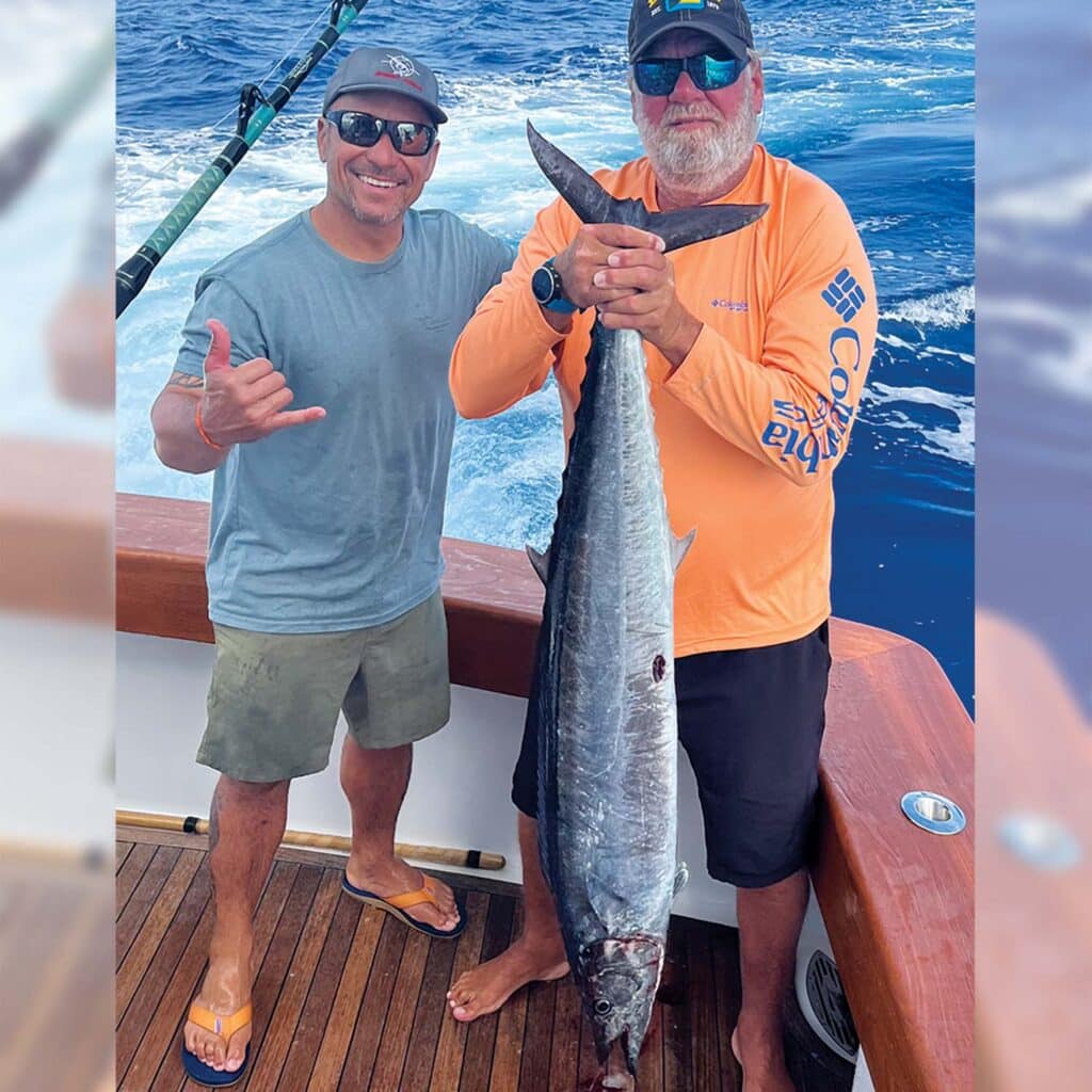Two anglers pose with a large wahoo 'ono' fish.