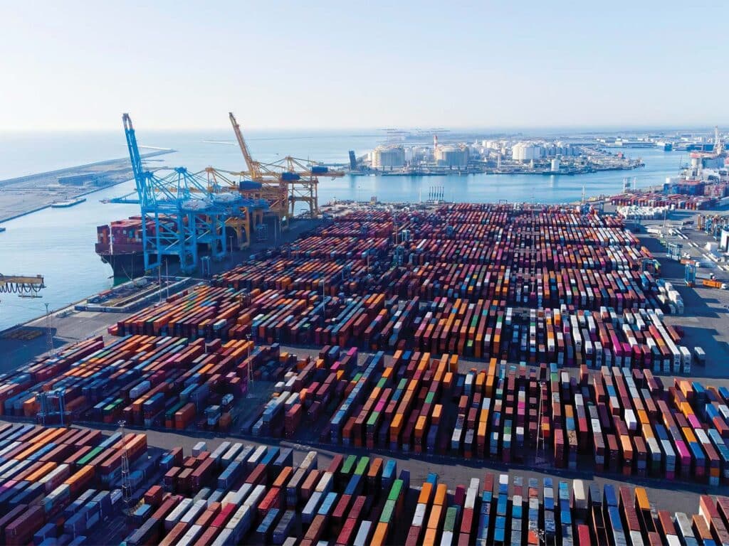 Aerial view of shipping freighter units lining a dock.