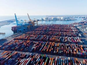 Aerial view of shipping freighter units lining a dock.