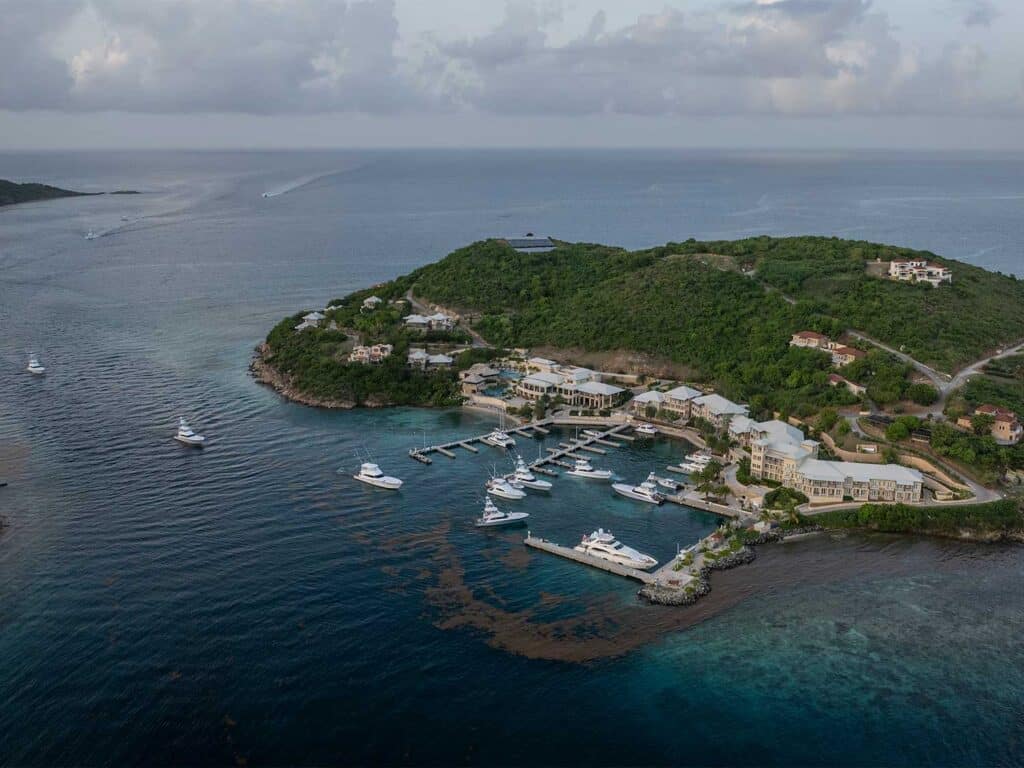 Aerial view of the North Drop around the Scrub Island Resort and Marina. Boats can be seen maneuvering into docks.