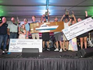 Team Waterman at the 2025 Virginia Beach Billfish Tournament Awards ceremony. the team holds up oversized checks and other prizes.