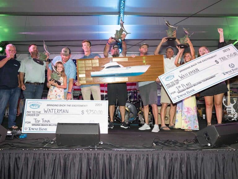 Team Waterman at the 2025 Virginia Beach Billfish Tournament Awards ceremony. the team holds up oversized checks and other prizes.