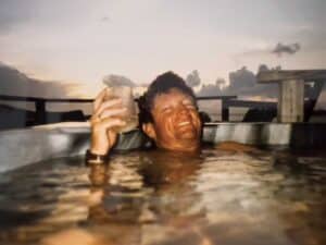 Vintage photo of Tim Choate relaxing in a hot tub.