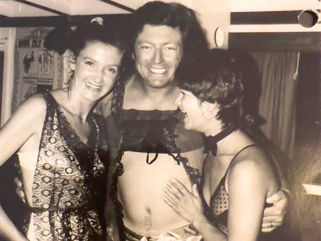 Black and white photo of Tim Choate at a party.