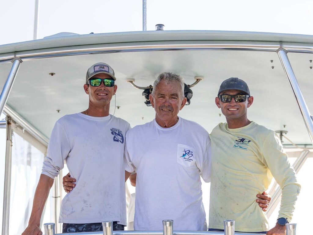 Capt. Rom Whitaker and his two grown up sons.