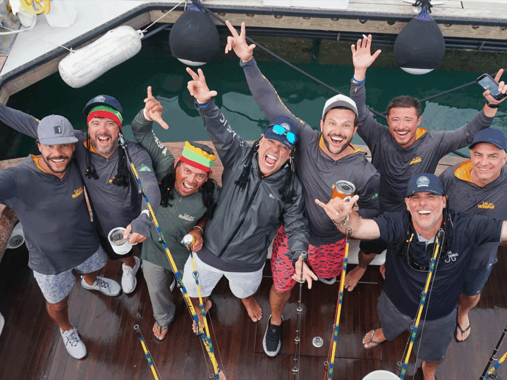 A group of anglers celebrate from the cockpit of a sport-fishing boat docks of Marina Pez Vela