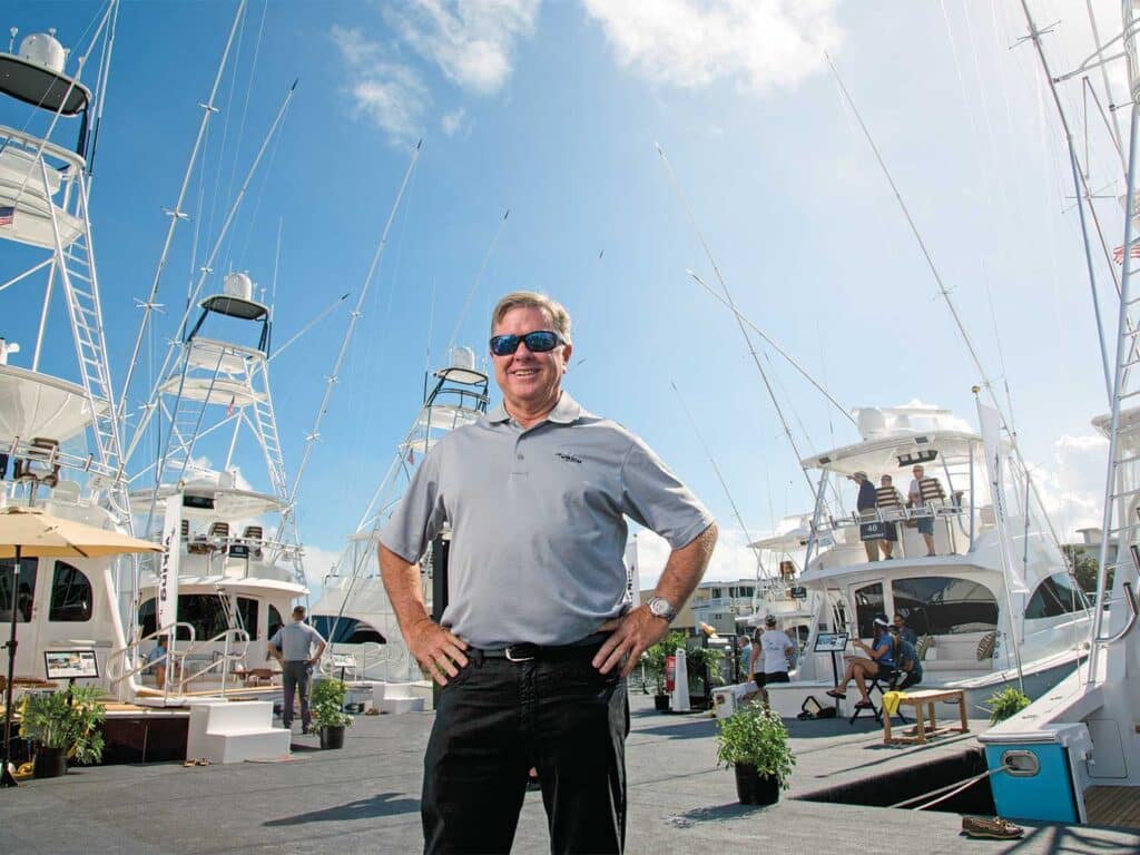 Patrick Healey standing near several viking yachts.