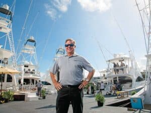 Patrick Healey standing near several viking yachts.