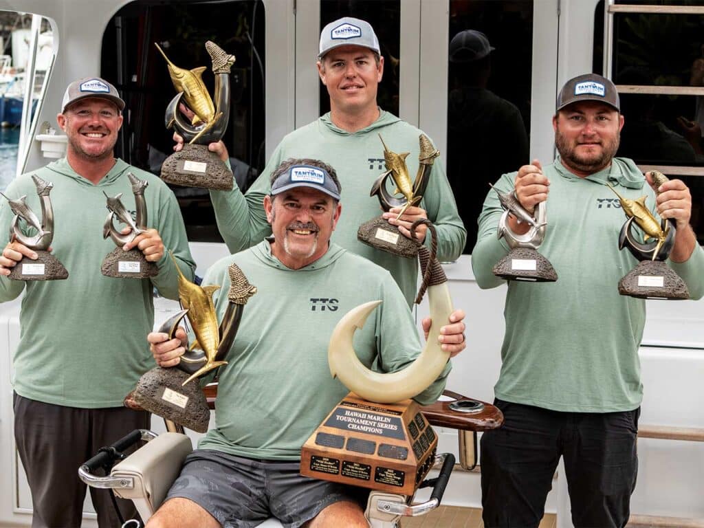 Team Tantrum crew holding up trophies at the Hawaii Marlin Tournament Series.