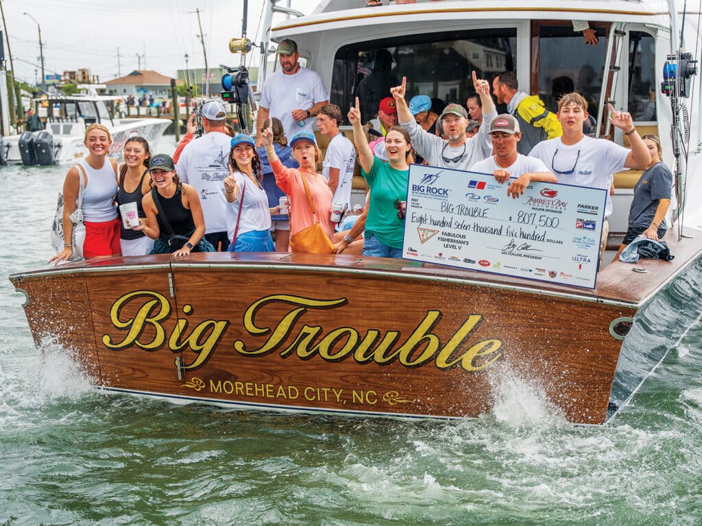 Big Rock Blue Marlin Tournament winners celebrate and hold up an oversized check.