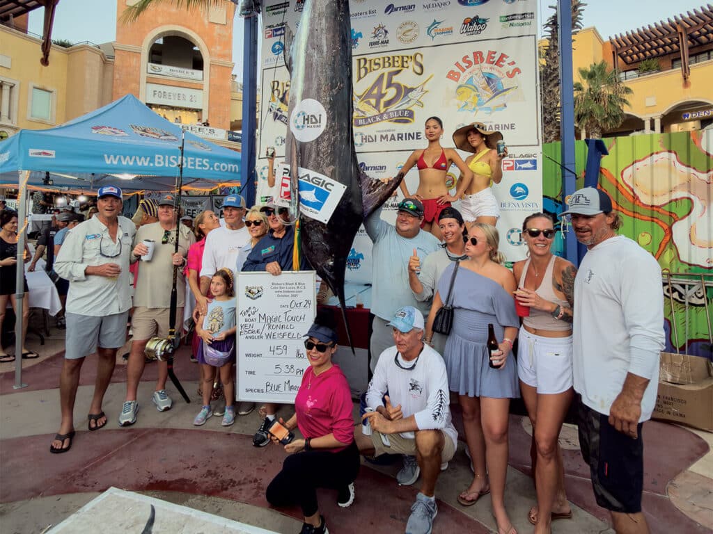 Team Magic Touch standing beside a large marlin at the Bisbee's Black & Blue.