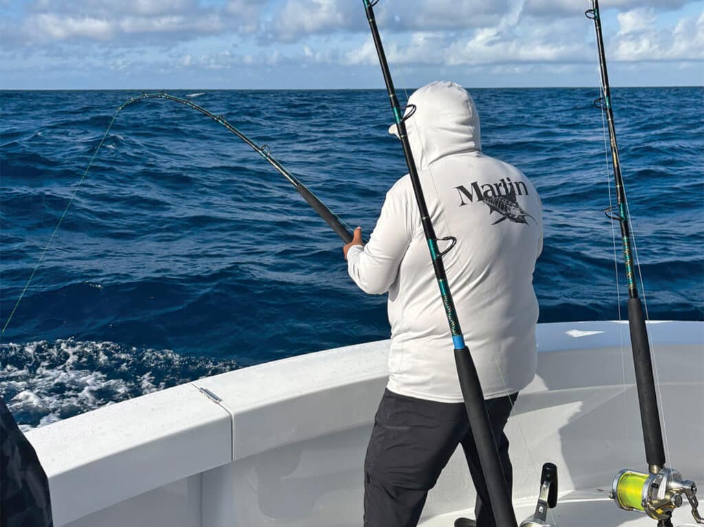 An angler fishing from the cockpit of a sport-fishing boat.
