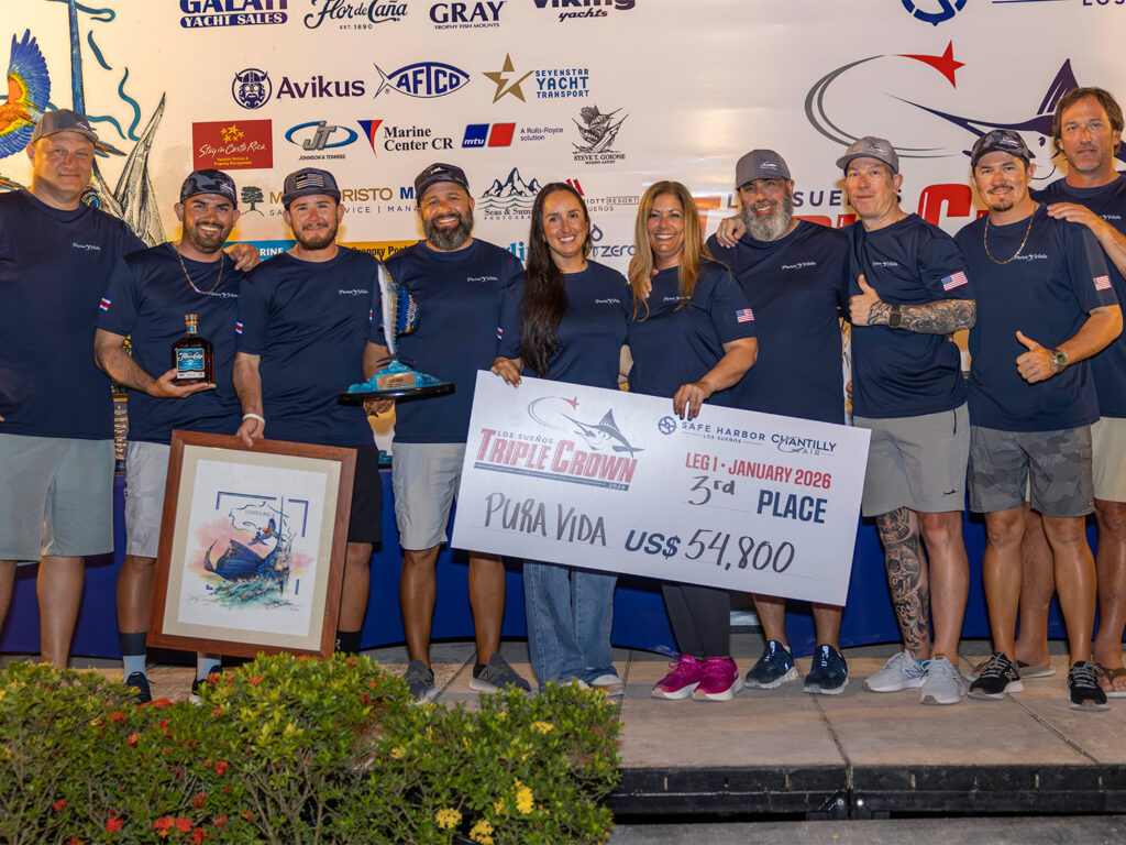 Team Pura Vida at the 2026 Los Suenos Signature Triple Crown Awards ceremony. They hold up an oversized check.