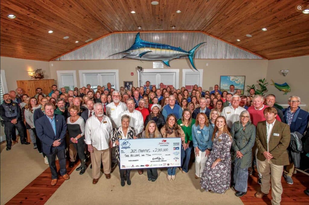 Group photo with large check presentation.
