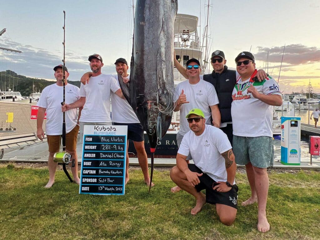 A group of anglers next to a large blue marlin.