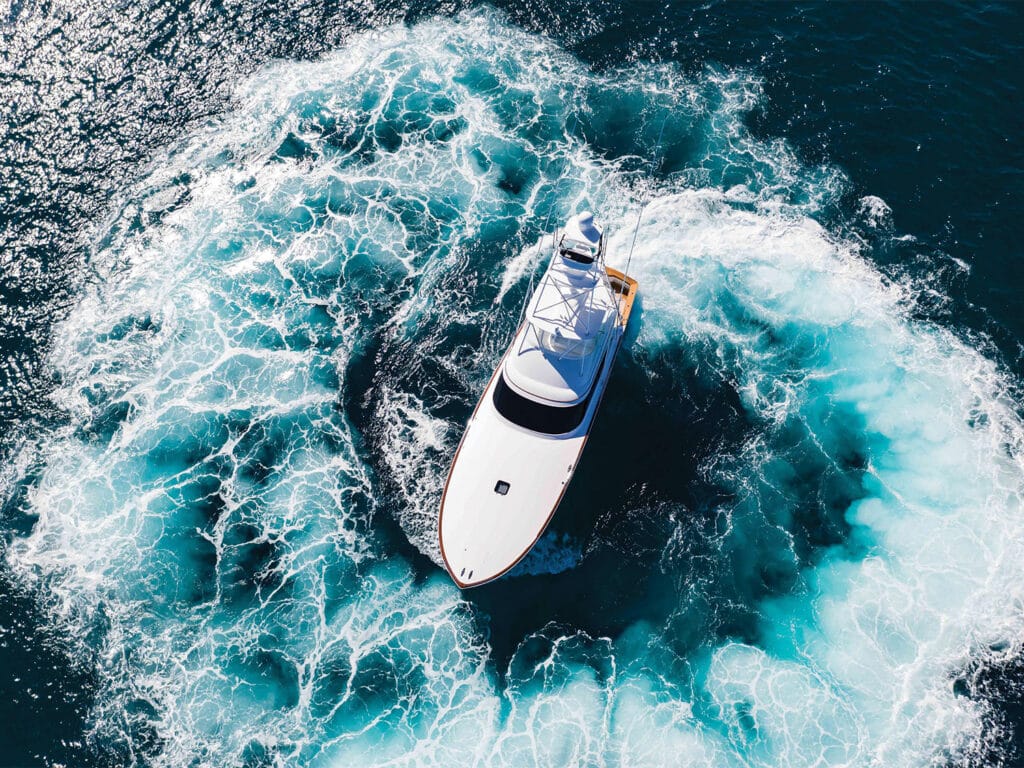 Aerial view of a sport-fishing boat making a tight turn.