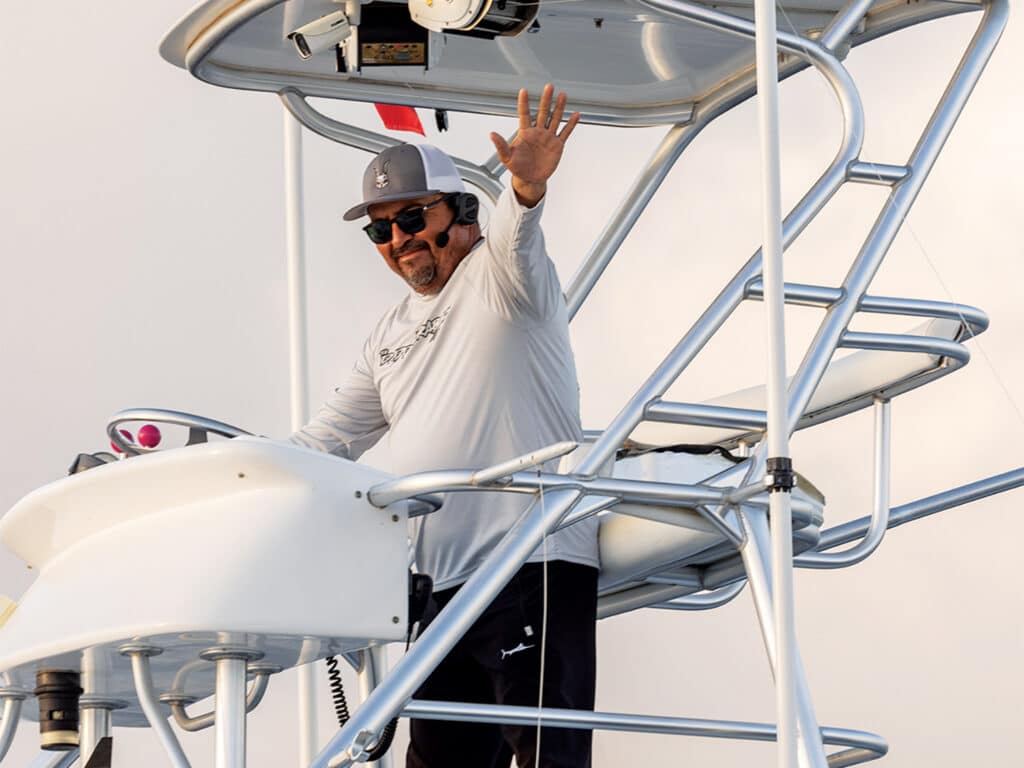A boat captain in the tower of a sport-fishing boat