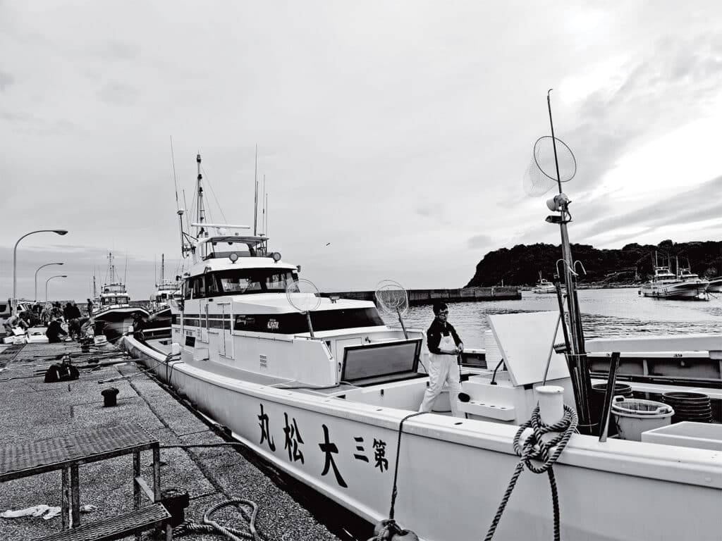 A black and white image of Japanese fishing vessels.