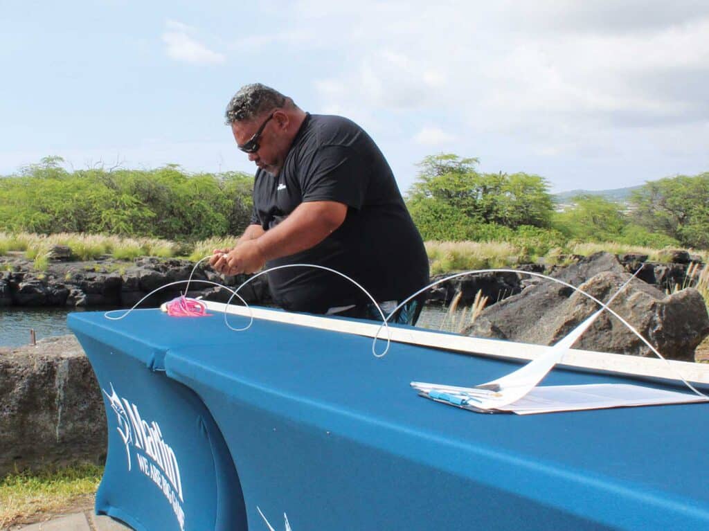 Tournament staff measuring IGFA leader length.